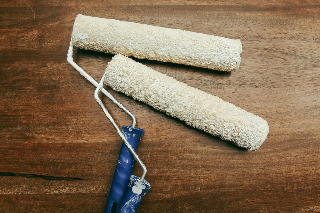 Paint rollers with blue handle. Renovation timeline