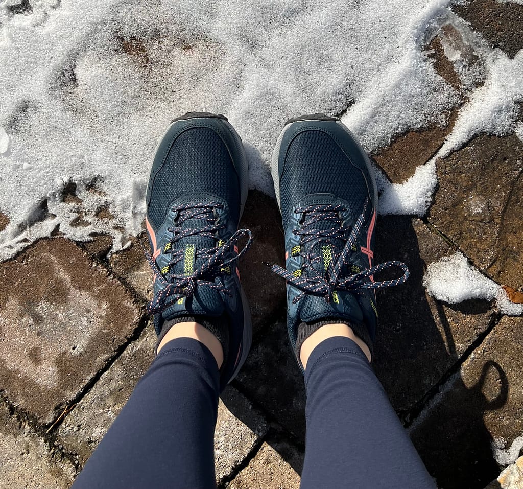 exercise shoes and snow on stone path